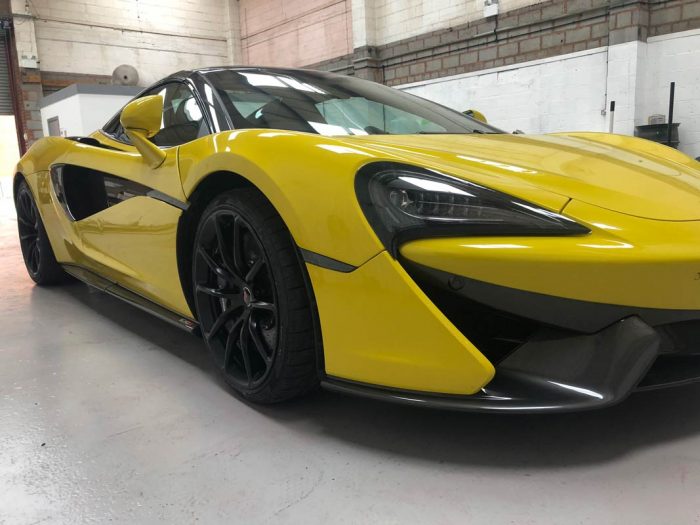 Alloy wheels repaired on yellow sports car at our shop in Birmingham.